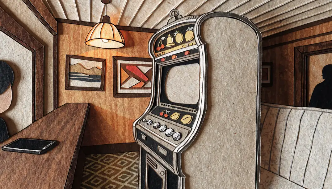 Classic UK fruit machine cabinet beside a face-down smartphone in a pub arcade.